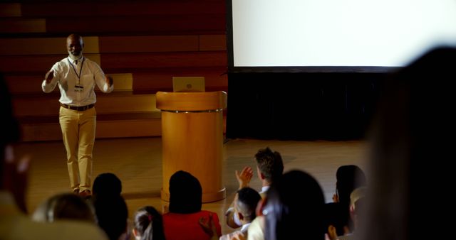 Business Professional Giving Presentation to Engaged Audience in Auditorium - Download Free Stock Images Pikwizard.com