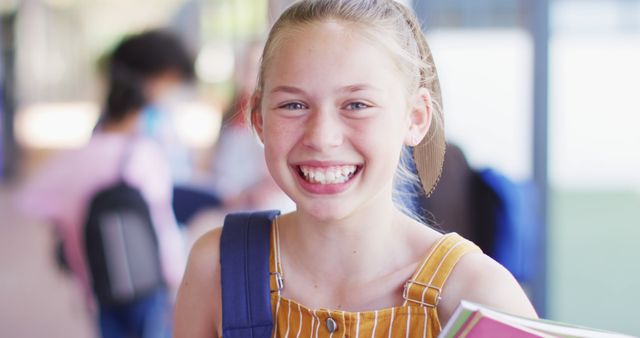 Smiling Elementary Student Holding Books Corridor - Download Free Stock Images Pikwizard.com