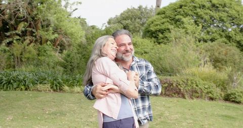 Senior Couple Embracing in Sunny Park Scene