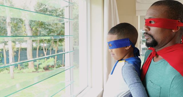 Father and Son Wearing Superhero Costumes Looking Out Window - Download Free Stock Images Pikwizard.com