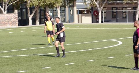 Youth soccer match with intense competition on green field