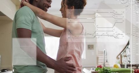 Couple embracing in bright kitchen preparing fresh produce and sharing affection