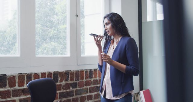 Businesswoman Speaking on Smartphone in Modern Office - Download Free Stock Images Pikwizard.com