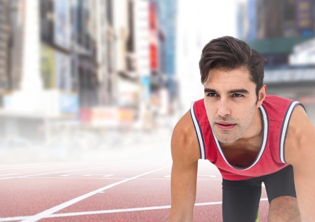 Male athlete in starting position on a track lane with blurry cityscape featuring tall buildings in the background, conveys themes of athleticism, urban health, and competitive spirit. Ideal for use in fitness advertisements, sports event promotions, motivational posters, and urban lifestyle content.