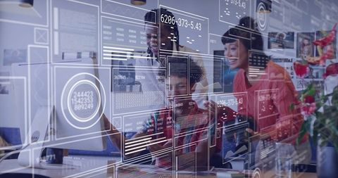 Team Analyzing Digital Data Interfaces at Modern Workspace