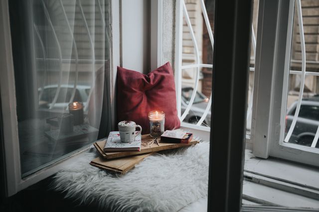Cozy Window Reading Nook with Candlelight and Cappuccino - Download Free Stock Photos Pikwizard.com