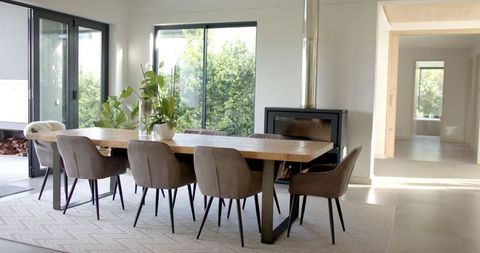 Modern Dining Room with Large Windows and Cozy Fireplace Lighting - Download Free Stock Images Pikwizard.com