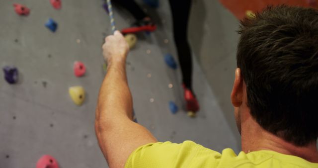 Male rock climbing instructor holding safety rope - Download Free Stock Images Pikwizard.com