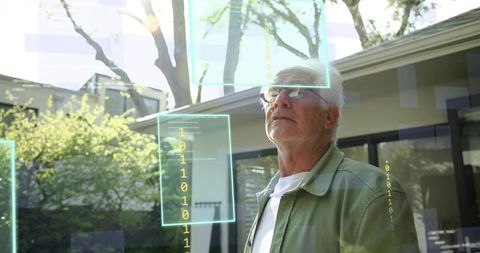 Senior man exploring augmented reality panels in backyard smart home