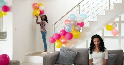 Mother and daughter bond over home celebration balloon decoration