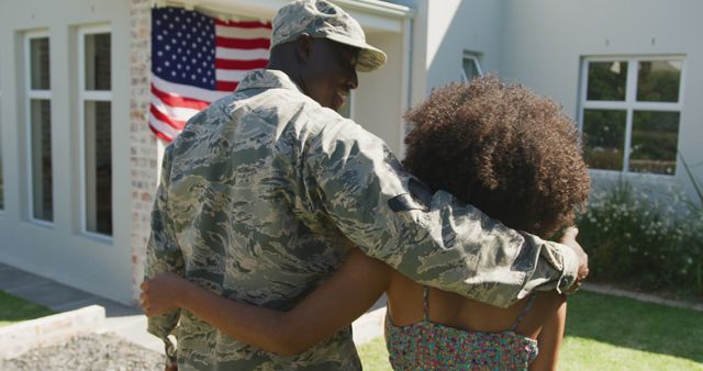 Image of african american soldier and his wife back home together. American patriotism, armed forces and family life.