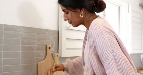 Young Woman Cooking in Modern Minimalist Kitchen