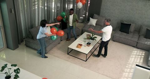 Diverse Group Decorating Room with Balloons in Celebration