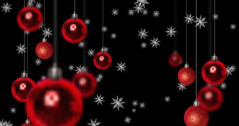 Festive Red Christmas Baubles with Falling Snowflakes on Black Background