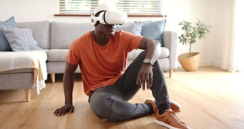 Relaxed Man Using VR Headset in Modern Living Room