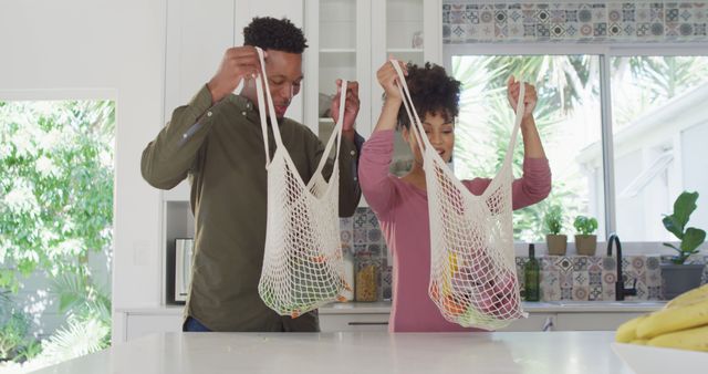 Couple Unpacking Groceries in Kitchen Using Reusable Bags - Download Free Stock Images Pikwizard.com