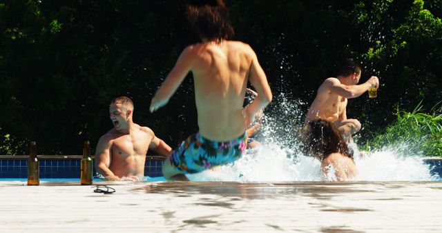 A group of young Caucasian boys are captured mid-action as they jump into a swimming pool, with copy space. Their playful energy and the bright summer day create a vibrant scene of youthful enjoyment and leisure.