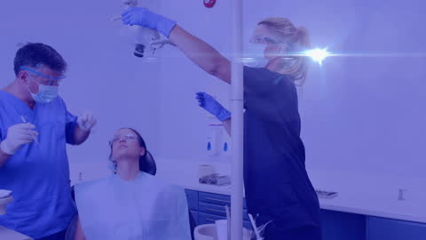 Professional Dentist and Assistant in Modern Dental Clinic Room