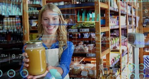 Smiling female grocer holding jar of honey in rustic bulk store with digital analytics overlays