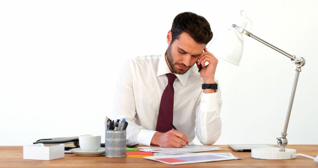 Businessman Working at Desk Reviewing Documents - Download Free Stock Images Pikwizard.com