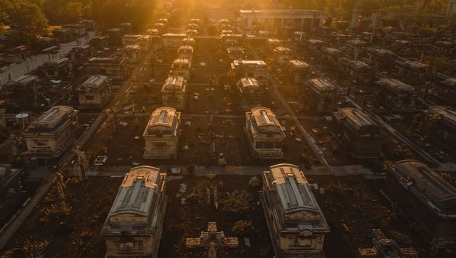 Sunlit aerial rows of mausoleums at golden hour in historic cemetery