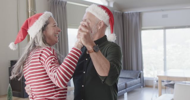 Happy Elderly Couple Dancing in Living Room Wearing Santa Hats - Download Free Stock Images Pikwizard.com