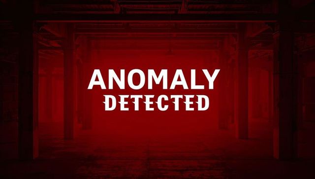 Anomaly detected warning signage in empty industrial warehouse with red lighting and haze