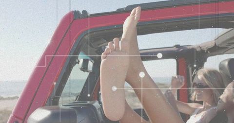 Friends Enjoying Summer Road Trip in Open-Top SUV Near Beach