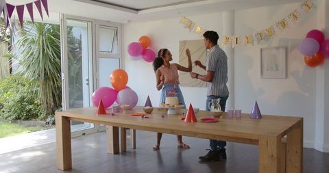 Joyful Couple Preparing Surprise Birthday Celebration