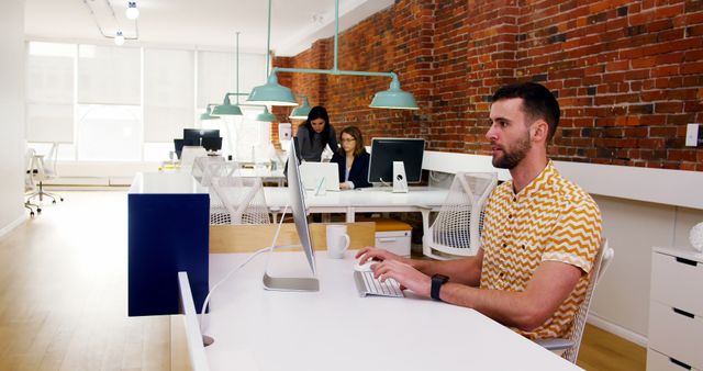 Modern Open Office Workspace with Brick Wall and Employees Working - Download Free Stock Images Pikwizard.com