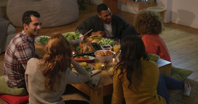 Friends Sitting Around a Table Enjoying Dinner at Home - Download Free Stock Images Pikwizard.com