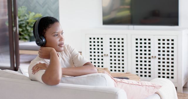 Relaxed Woman Listening to Music on Headphones at Home - Download Free Stock Images Pikwizard.com