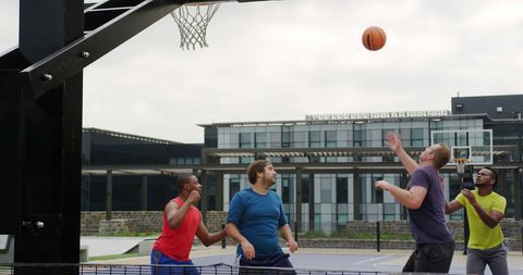 Group of Basketball Players Competing on Outdoor Court