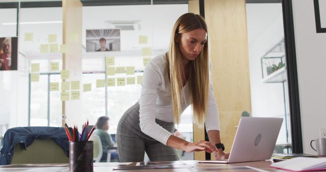 Young Woman Working on Laptop in Modern Office Space - Download Free Stock Images Pikwizard.com