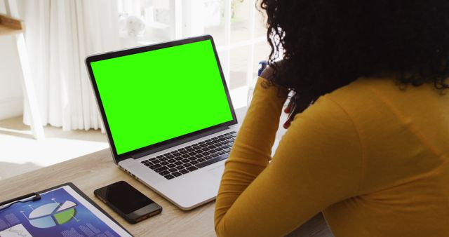 Woman in Yellow Working on Laptop with Green Screen in Office - Download Free Stock Images Pikwizard.com