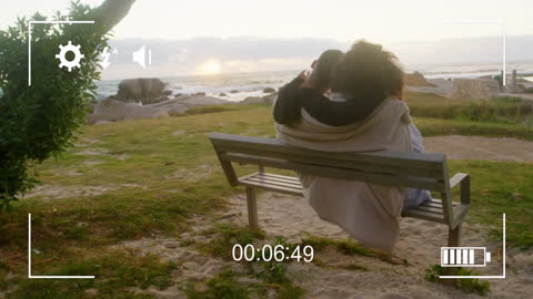 Romantic Couple Relaxing on Beachfront Bench