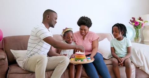 African American Family Celebrating Birthday with Cake at Home