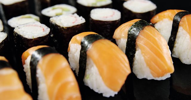 Variety of Freshly Prepared Sushi Rolls and Nigiri on Black Plate - Download Free Stock Images Pikwizard.com