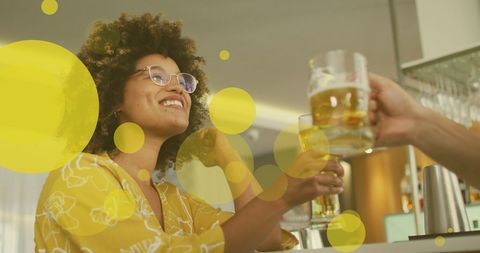 Joyful Biracial Woman Toasting Beer with Friend - Download Free Stock Images Pikwizard.com