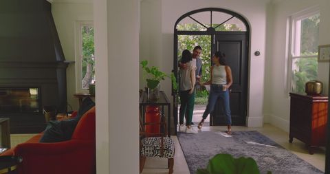 Cheerful Friends Chatting in Modern Living Room