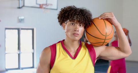 Confident Young Basketball Player on Indoor Court