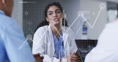 Doctor presenting clinical data to colleagues with digital analytics overlay and laptop