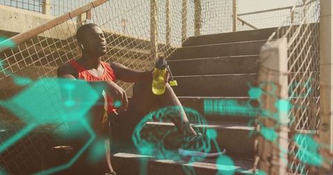 Tired athlete sitting on stairs with medical overlay graphics