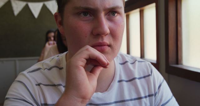 Young man deep in thought in cozy cafe - Download Free Stock Images Pikwizard.com