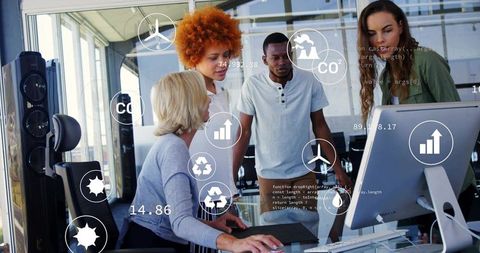 Sustainability team collaborating on co2 dashboard with wind turbine and recycling metrics