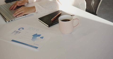 Professional Female Worker Typing at Modern Office Desk with Documents
