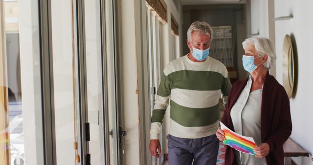 Elderly Couple Wearing Masks Holding Rainbow Drawing - Download Free Stock Images Pikwizard.com