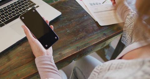 Pregnant Woman Working at Home with Laptop and Smartphone