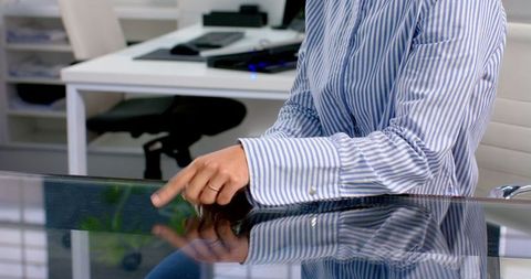 Woman Using Touchscreen Desk in Modern Office for Multitasking