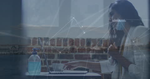 Woman in Face Mask Using Laptop in Modern Office